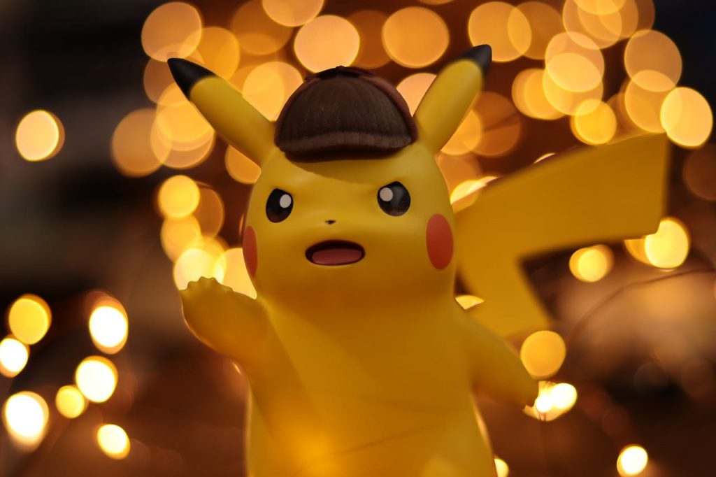 A close-up of a Pikachu figurine illuminated by a warm bokeh effect, creating an eye-catching visual.